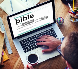 Man Reading the Definition of Bible